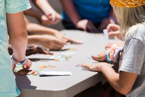 Image of children doing activities around a table